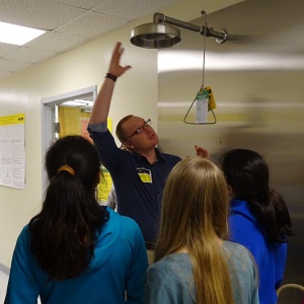 Human Toxicology student Nate Parizek is explaining the importance of a laboratory shower to junior high students from Columbus Junction School. 