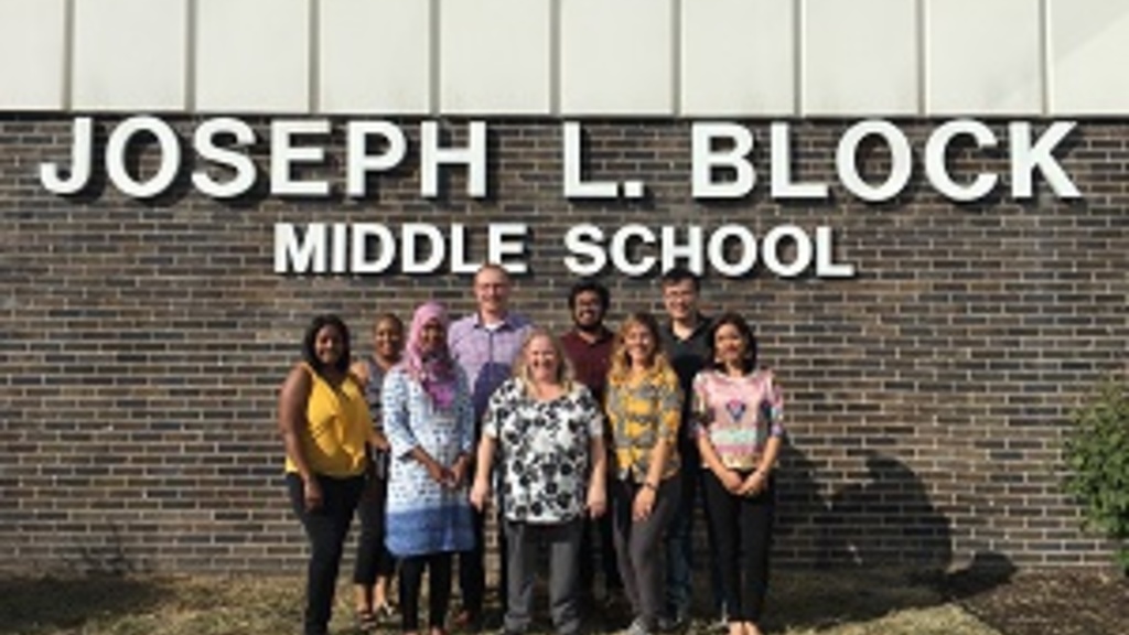 Group photo of trip members in front of Joseph L. Block Middle School.